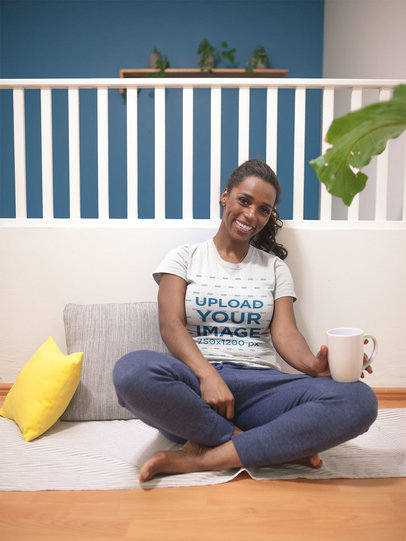 Mockup of a Woman Wearing a T-Shirt Sitting on the Floor 