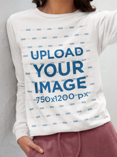 Bella Canvas Long-Sleeve Tee Mockup Featuring a Cropped-Face Woman Leaning on a Wall