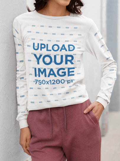 Bella Canvas Long-Sleeve Tee Mockup Featuring a Cropped-Face Woman Leaning Against a Wall