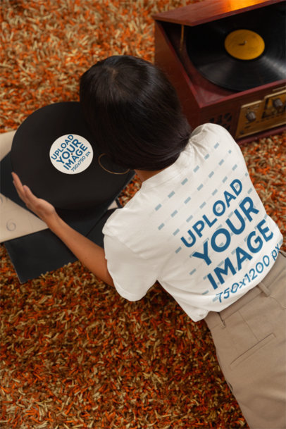 Back-View Bella Canvas T-Shirt Mockup Featuring a Woman With a Vinyl Album