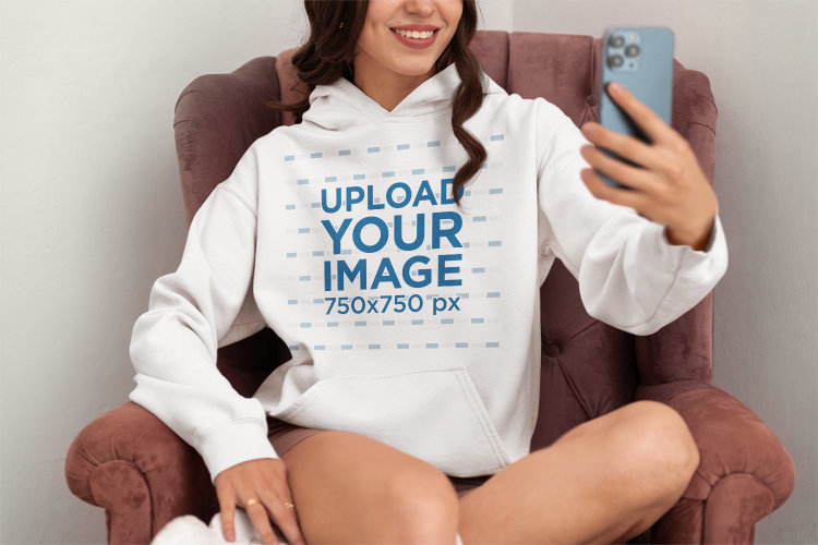 Gildan Hoodie Mockup of a Smiling Woman Taking a Selfie at Home
