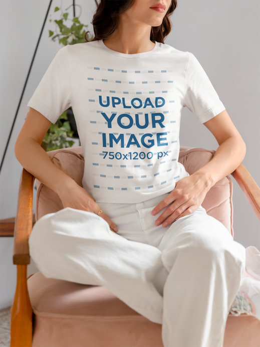 Mockup of a Woman Wearing a Bella Canvas T-Shirt on a Chair 