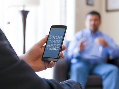 Android Mockup Template of Man Using LG G3 at a Meeting