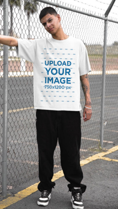 Yazbek T-Shirt Video Featuring a Tattooed Man Posing Near a Wire Fence
