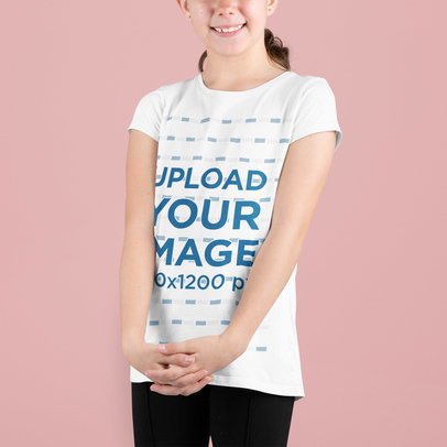 Round-Neck T-Shirt Mockup of a Smiling Girl Standing in a Studio