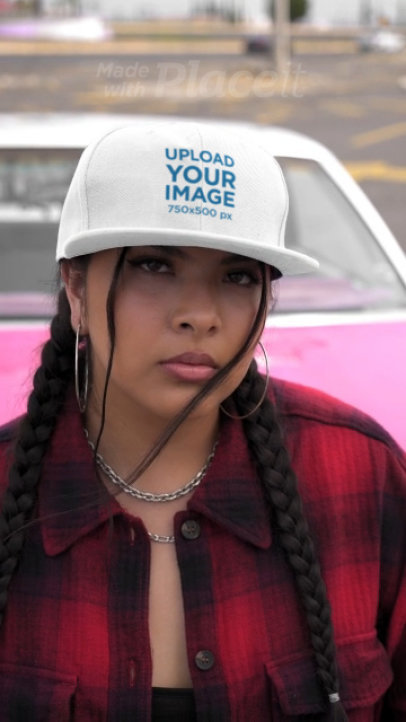Video of a Serious Woman Wearing a Snapback Hat While Standing Against a Car