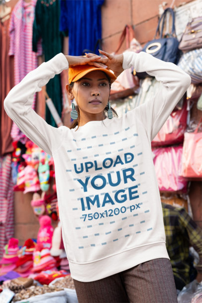 Sweatshirt Mockup Featuring a Serious Woman Posing in a Clothing Market