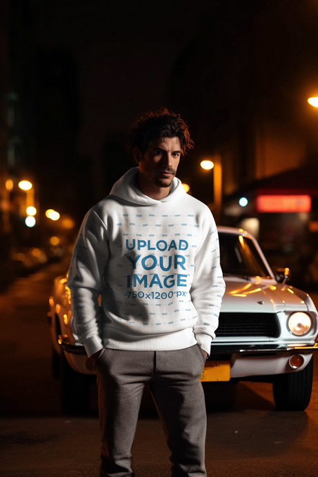 Cinematic-Style Pullover Hoodie Mockup of a Man Standing in Front of a Classic Car