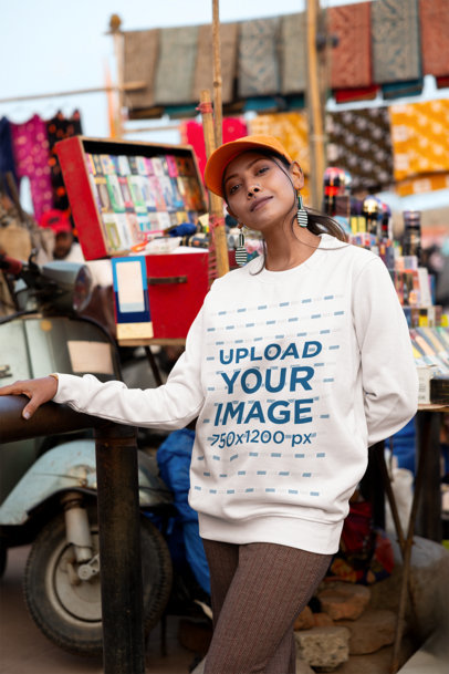 Mockup Featuring a Happy Woman Wearing a Round-Neck Sweatshirt at an Urban Market