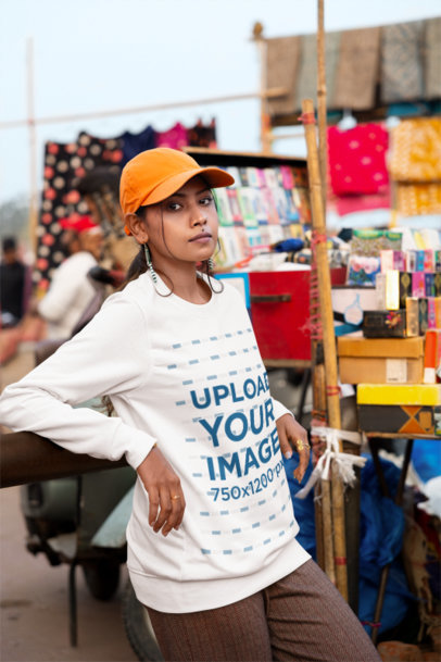 Sweatshirt Mockup Featuring a Serious Woman Posing in a Street Market