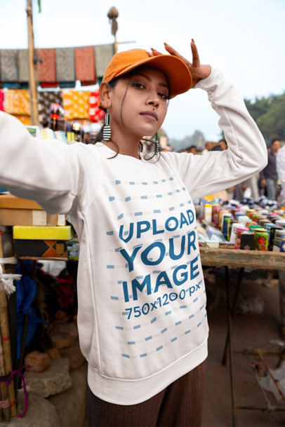 Sweatshirt Mockup Featuring a Woman Taking a Selfie in a Market