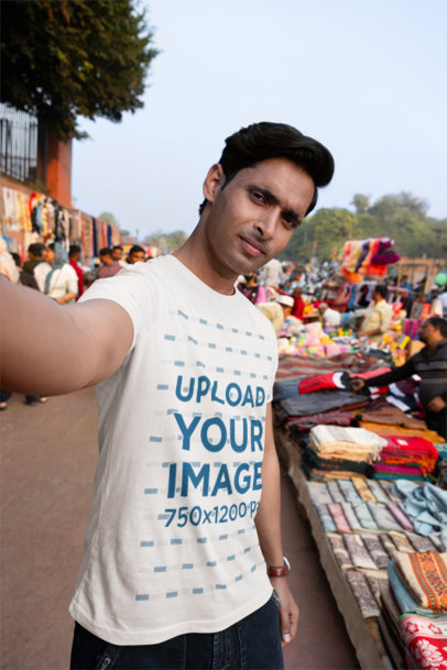 Scott International T-Shirt Mockup of a Man Taking a Selfie at a Street Market
