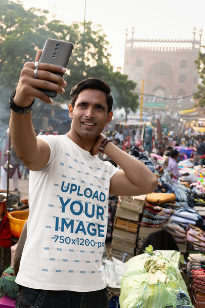 Scott International T-Shirt Mockup Featuring a Man Taking a Selfie in a Street Market