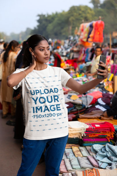 Scott International T-Shirt of a Woman Taking a Selfie at an Urban Market