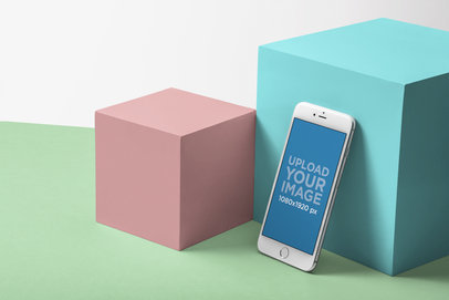 Mockup of a Silver iPhone 8 Plus Standing Against Color Cubes