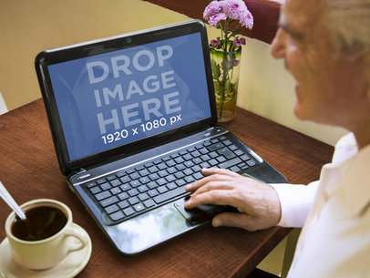 Elderly Gentleman Using HP Laptop While Enjoying a Coffee
