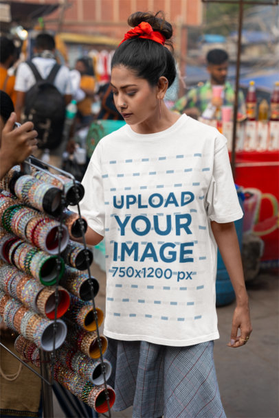 Blinkstore T-Shirt Mockup Featuring a Woman Shopping in a Street Market m37429