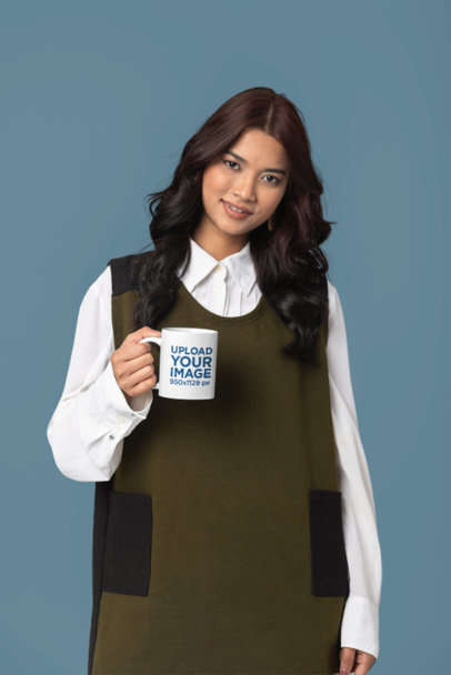 Mockup of a Smiling Woman Holding an 11 oz Coffee Mug in a Studio m37648