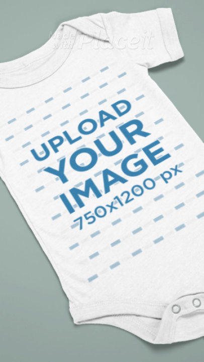 Video of a Bella Canvas Onesie Lying on a Customizable Background 7769v