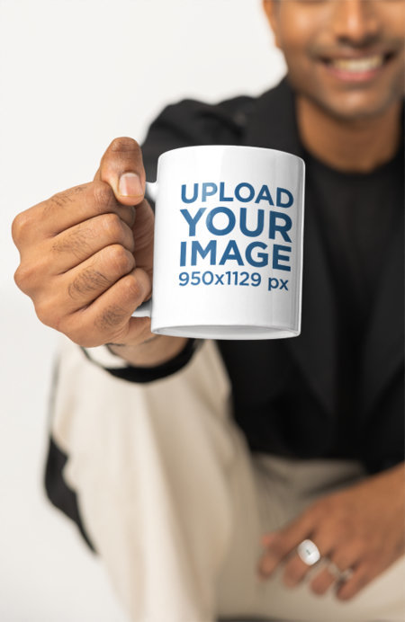Mockup of a Man Showing an 11 oz Coffee Mug Close to the Camera