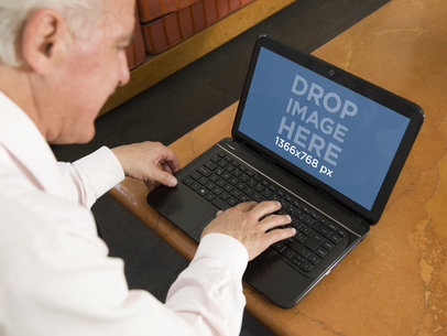 PC Mockup of an Elderly Man with a Laptop at Home