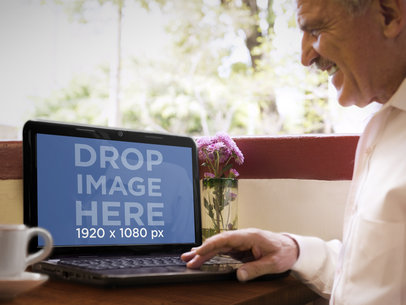 Mockup of an Elderly Man Using HP Laptop While Drinking Coffee In a Terrace