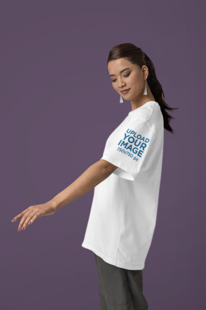 Mockup of a Woman Wearing an Oversized Blinkstore Tee with a Customizable Sleeve