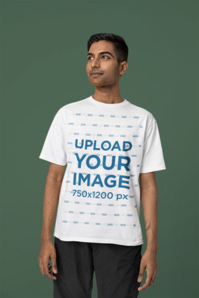 Blinkstore T-Shirt Mockup of a Man Posing With a Little Smile in a Studio