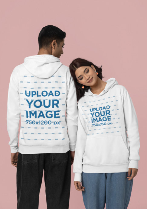 Mockup of a Man and a Woman Wearing Matching Pullover Hoodies from Gildan