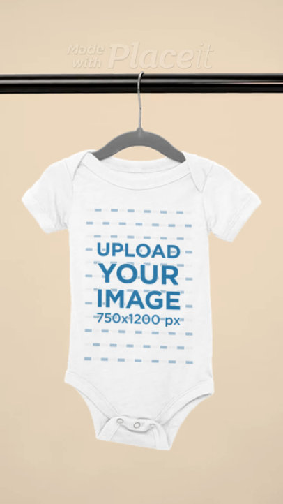 Video of a Bella Canvas Onesie Placed on a Wooden Hanger 7770v