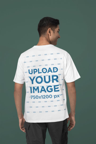 Back-View Blinkstore Tee Mockup Featuring a Smiling Man Standing in a Studio