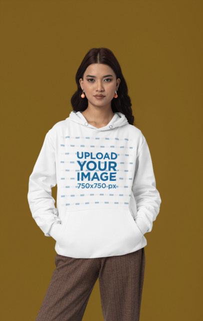Mockup Featuring a Woman Wearing a Hoodie from Gildan in a Studio