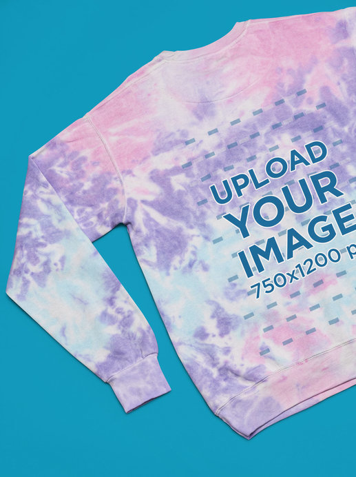 Back-View Mockup of a Colortone Tie-Dye Sweatshirt Flat Laid over a Solid Surface
