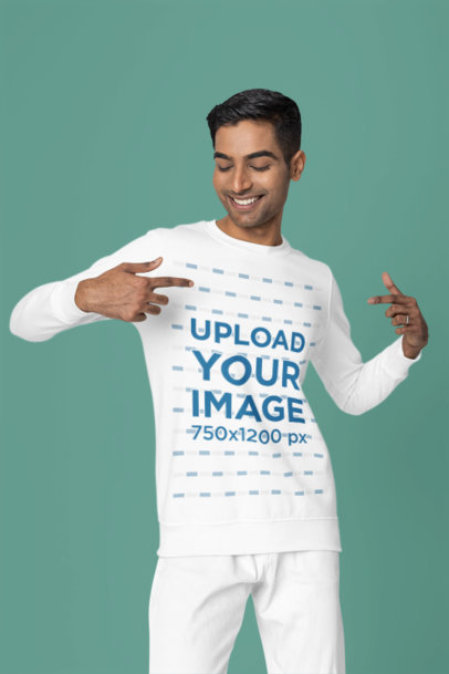 Mockup of a Happy Man Pointing at His New Crewneck Sweatshirt in a Studio