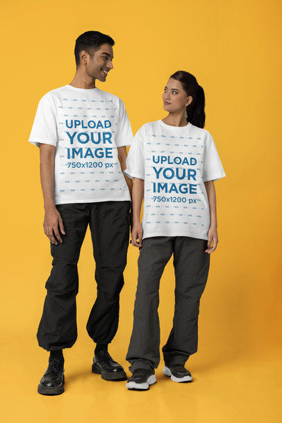 Blinkstore T-Shirt Mockup Featuring a Smiling Man and Woman Standing in a Studio