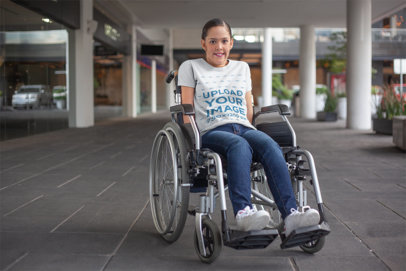 Mockup of a Woman Using a Wheelchair Wearing a T-Shirt