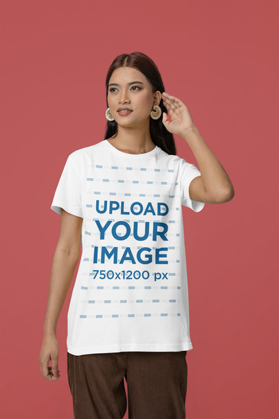 Mockup of a Woman Wearing a Scott International Tee and Big Earrings in a Studio