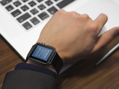 Mockup of a Businessman Working on Laptop With Black Apple Watch