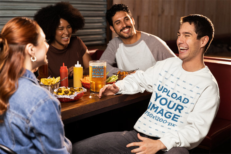 Sweatshirt Mockup Featuring a Man Eating in a Sports Bar with His Friends