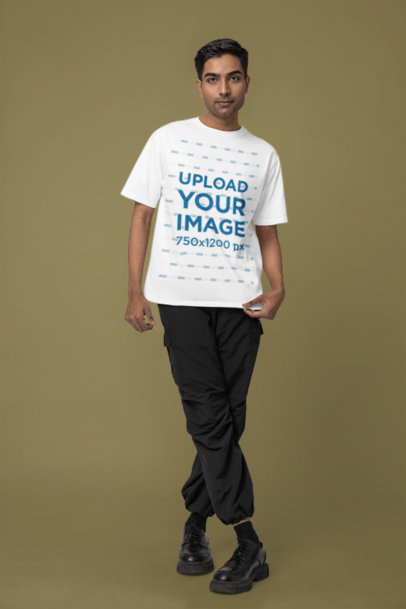 Mockup of a Man Standing in a Studio Wearing a Rounded-Neck T-Shirt from Blinkstore