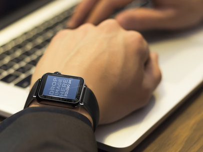 Businessman Typing on Laptop and Using Apple Watch Mockup