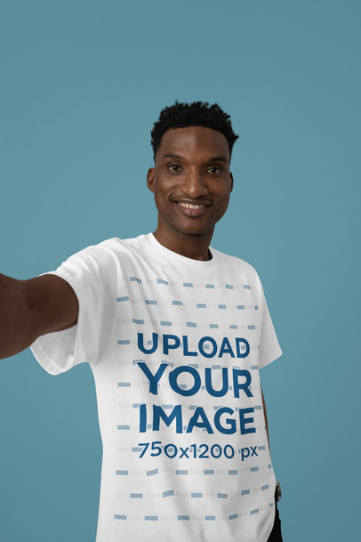 Round-Neck Tee Mockup Featuring a Joyful Man Taking a Selfie in a Studio