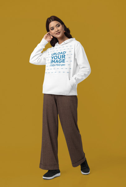 Gildan Pullover Hoodie Mockup of a Smiling Woman Posing Against a Colorful Backdrop