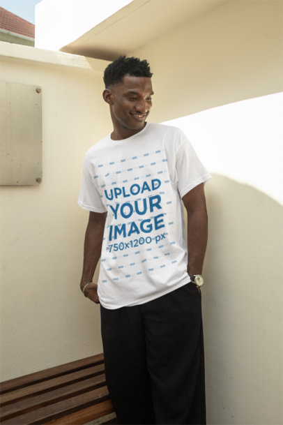 Round-Neck Tee Mockup Featuring a Smiling Standing Against a White Wall