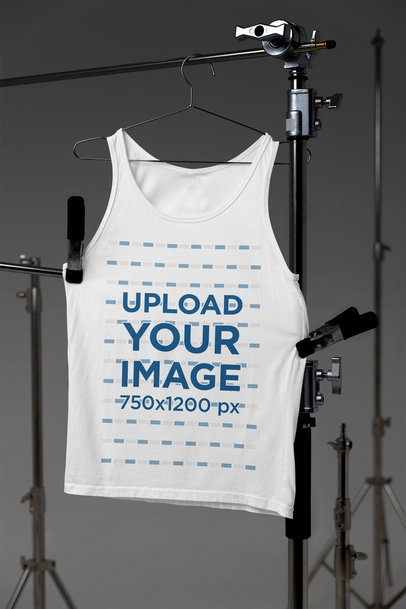 Mockup of a Bella Canvas Tank Top Hanging From a Professional Tripod m37634