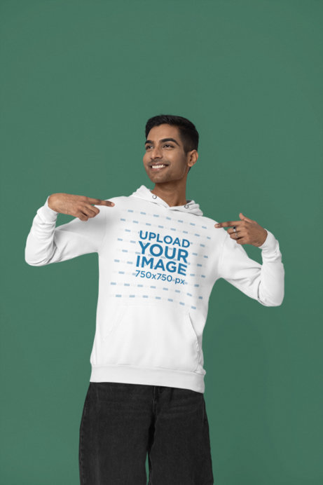 Mockup of a Happy Man Pointing at His Gildan Pullover Hoodie in a Studio