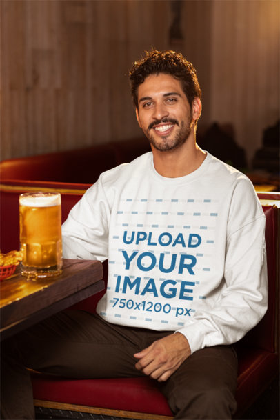 Gildan Sweatshirt Mockup Featuring a Smiling Man Having a Beer at a Sports Bar