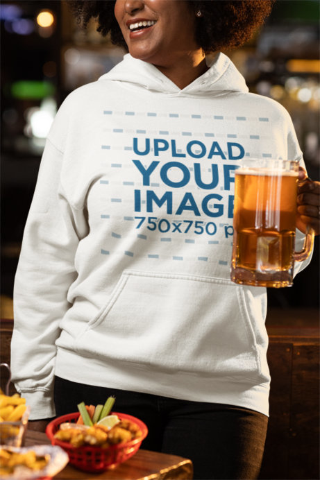 Mockup of a Smiling Woman Holding a Beer Glass in a Sports Bar