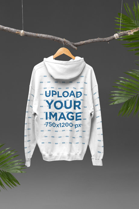 Mockup of a Back-View Gildan Hoodie Hanging From a Branch