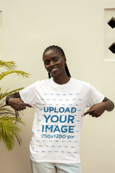 Mockup of a Happy Woman with Braids Pointing at Her New T-Shirt